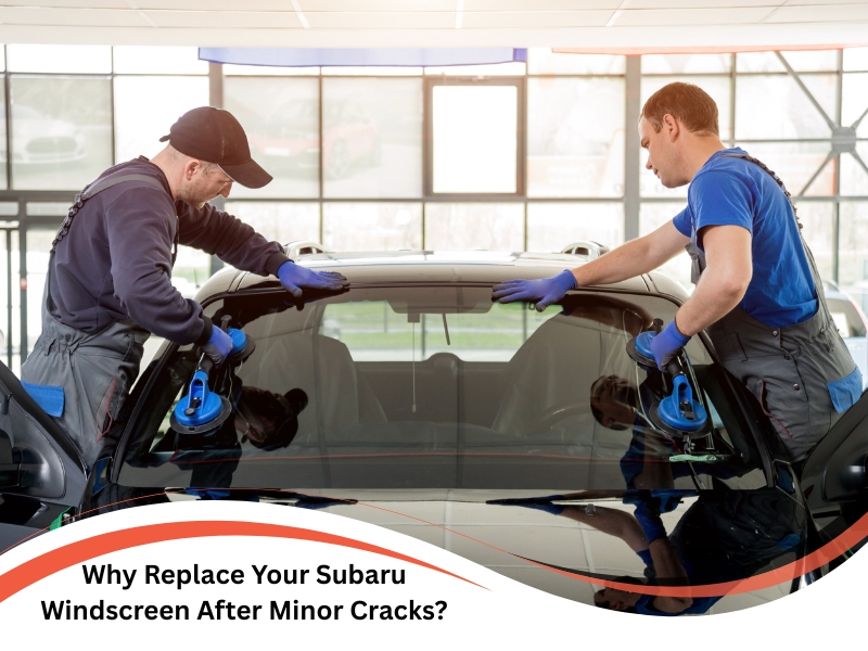 Technicians performing Subaru windscreen replacement after detecting minor cracks in a vehicle.